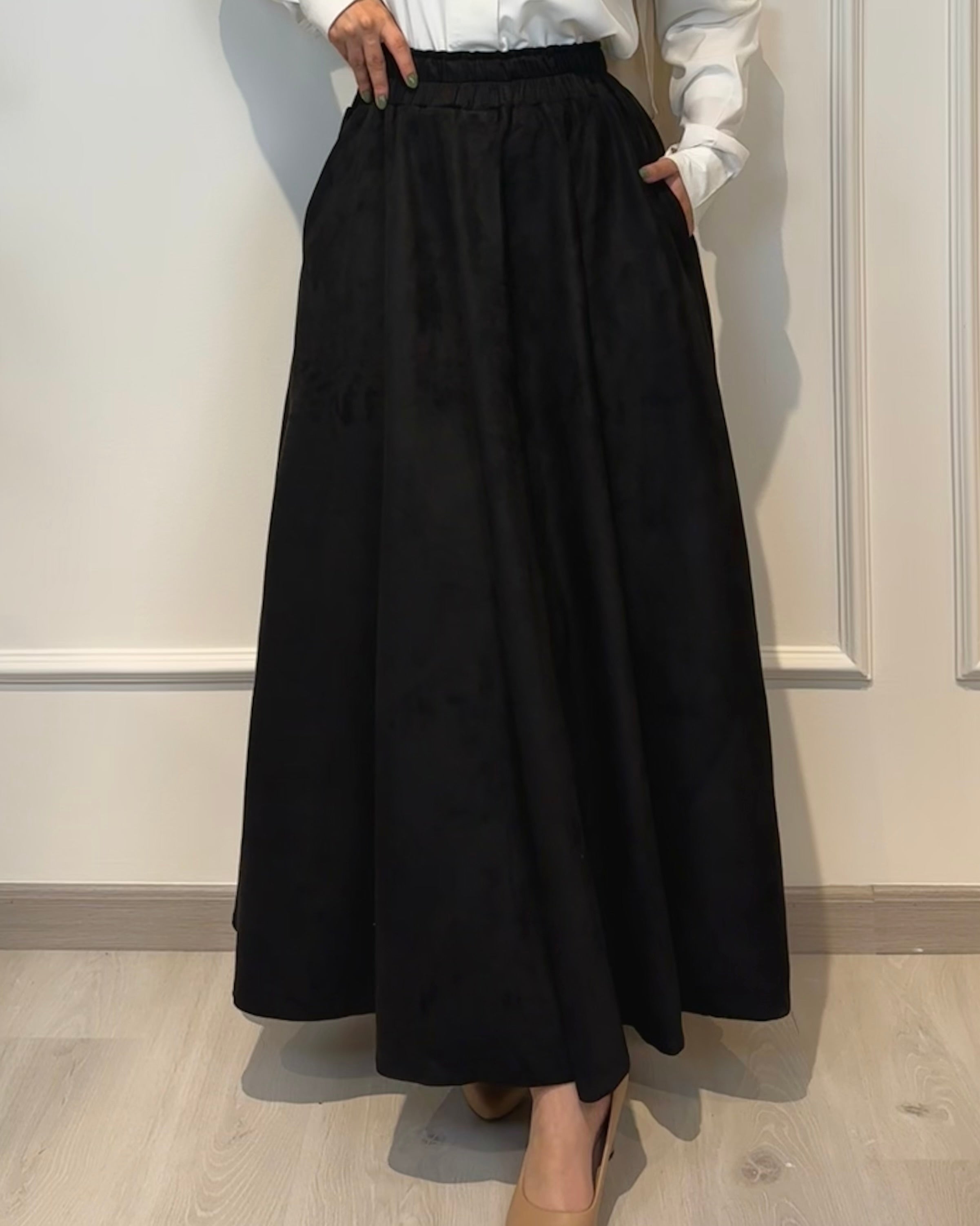 Black full cloche suede skirt with soft texture and elegant modest style