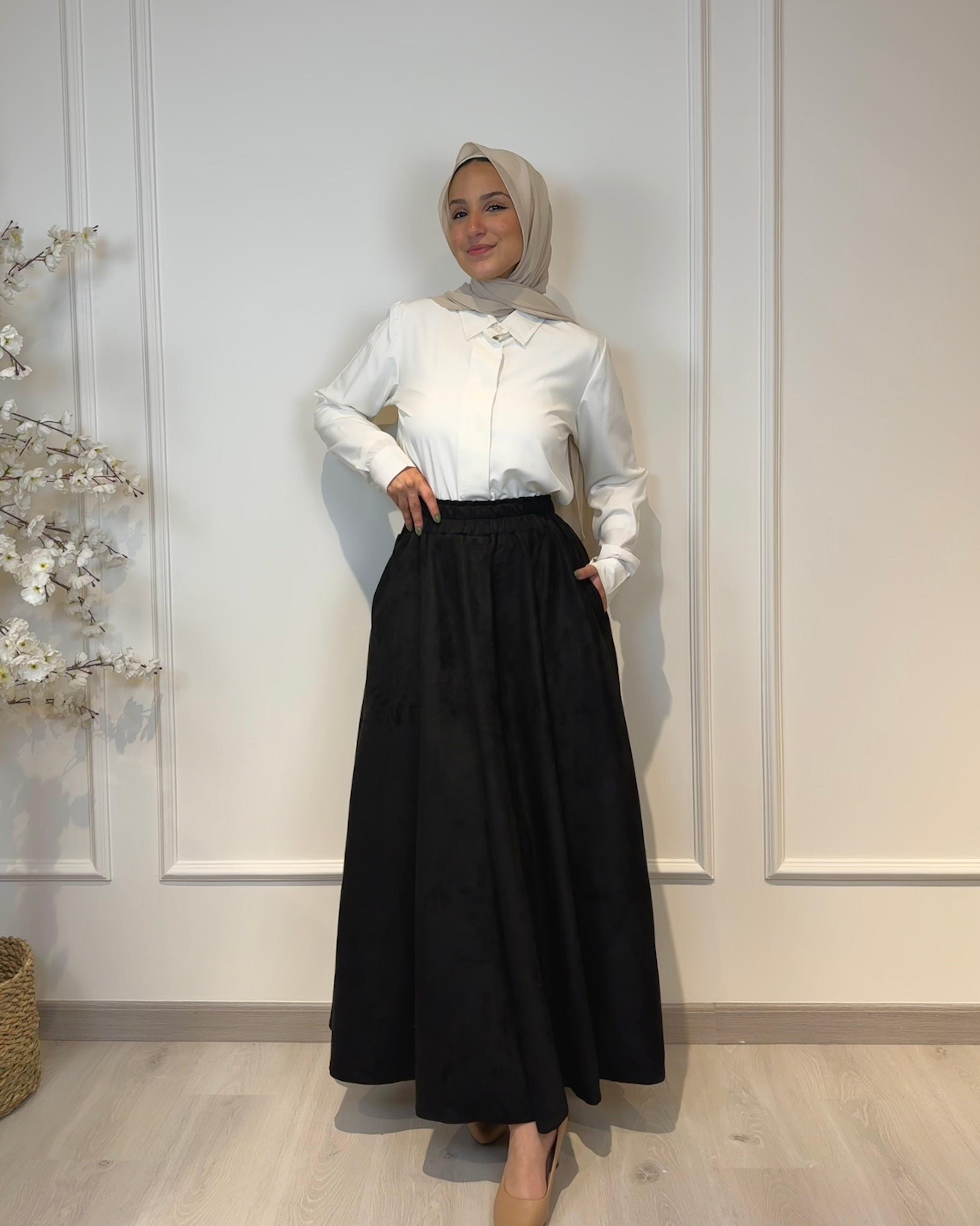 Black full cloche suede skirt with soft texture and elegant modest style